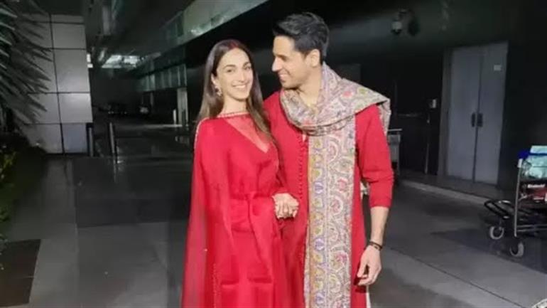 Newlyweds Sidharth Malhotra and Kiara Advani twin in red as they walk out of airport holding hands, pose for paparazzi